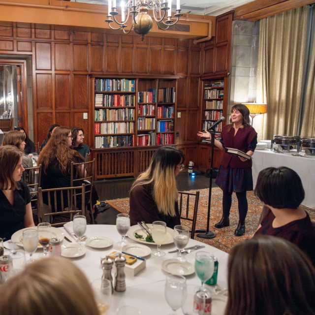 Speaker addressing a room of individuals