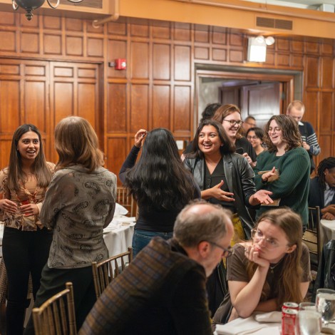 Students discussing in a wood-paneled room